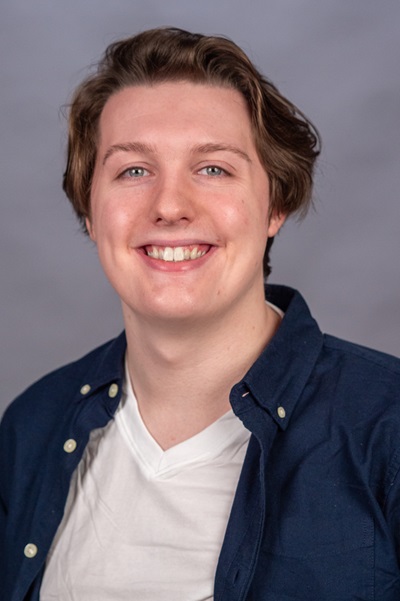 Ethan Kelloway wearing a blue denim jacket and smiling at the camera