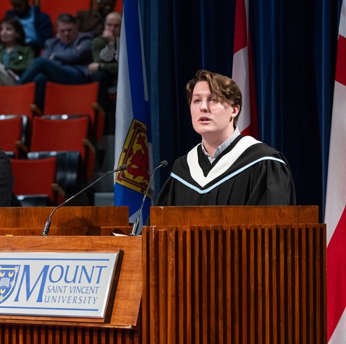 Ethan Kelloway delivering the valedictorian address at the morning Fall 2026 Convocation ceremony