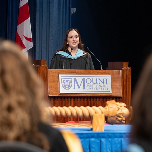 Sarah Monette delivering the valedictorian address at the afternoon Fall 2026 Convocation ceremony